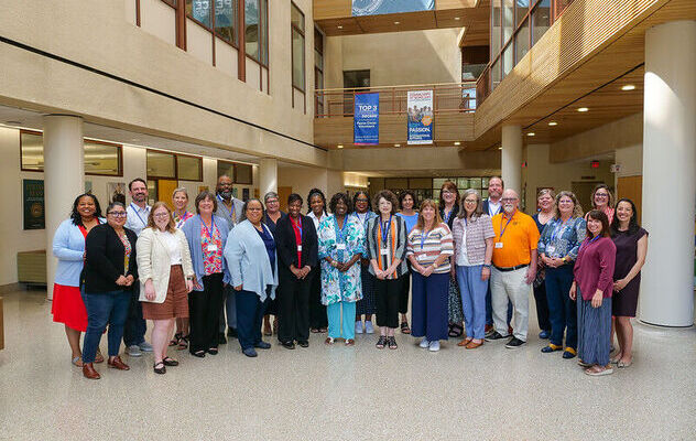 Impact Academy fellows and coaches posing together as a group