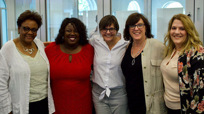 Gaetane Jean-Marie posing for a group photo with 4 other leaders